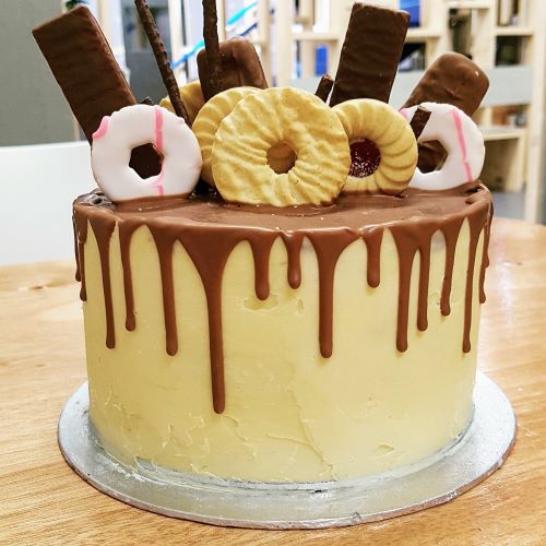 A very yummy Chocolate drip cake laden with biscuits and chocolate bars