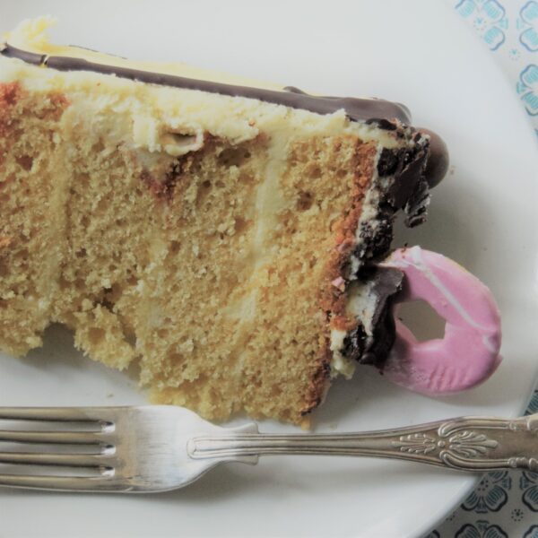 A slice of vanilla cake ready to be eaten