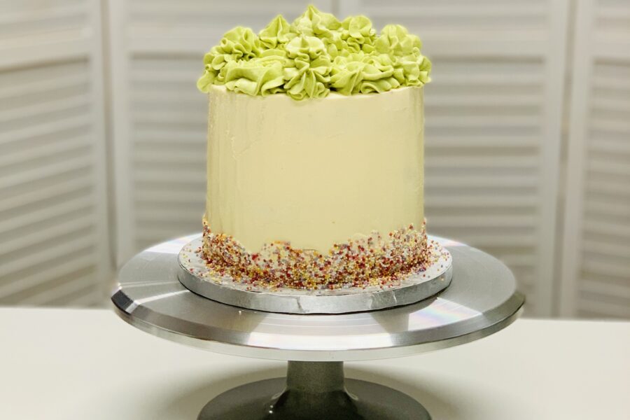 The London Cake Academy UK shows a cake decorated in buttercream and sprinkles with green frosting on top