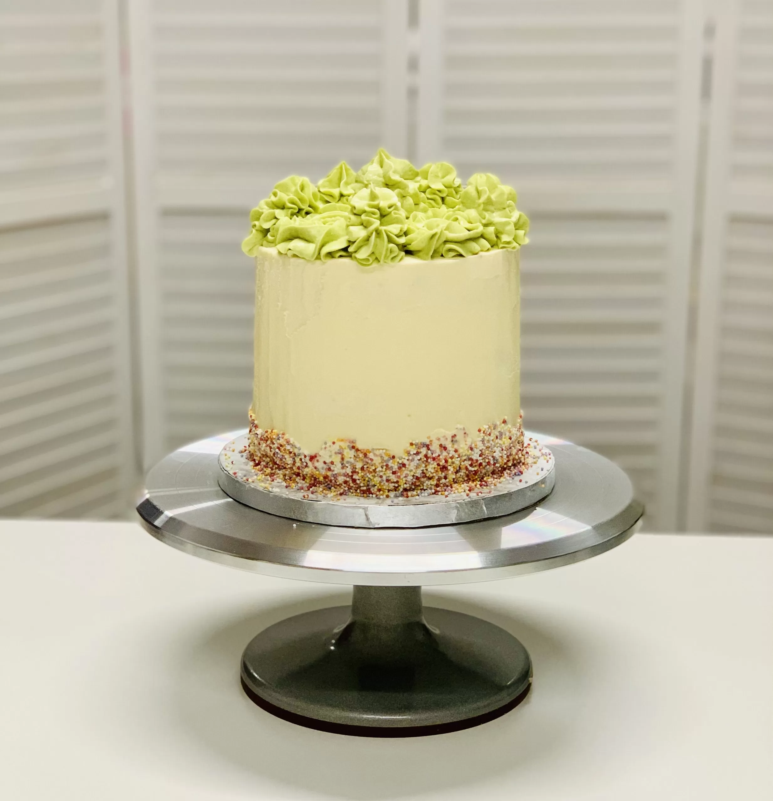 The London Cake Academy UK shows a cake decorated in buttercream and sprinkles with green frosting on top